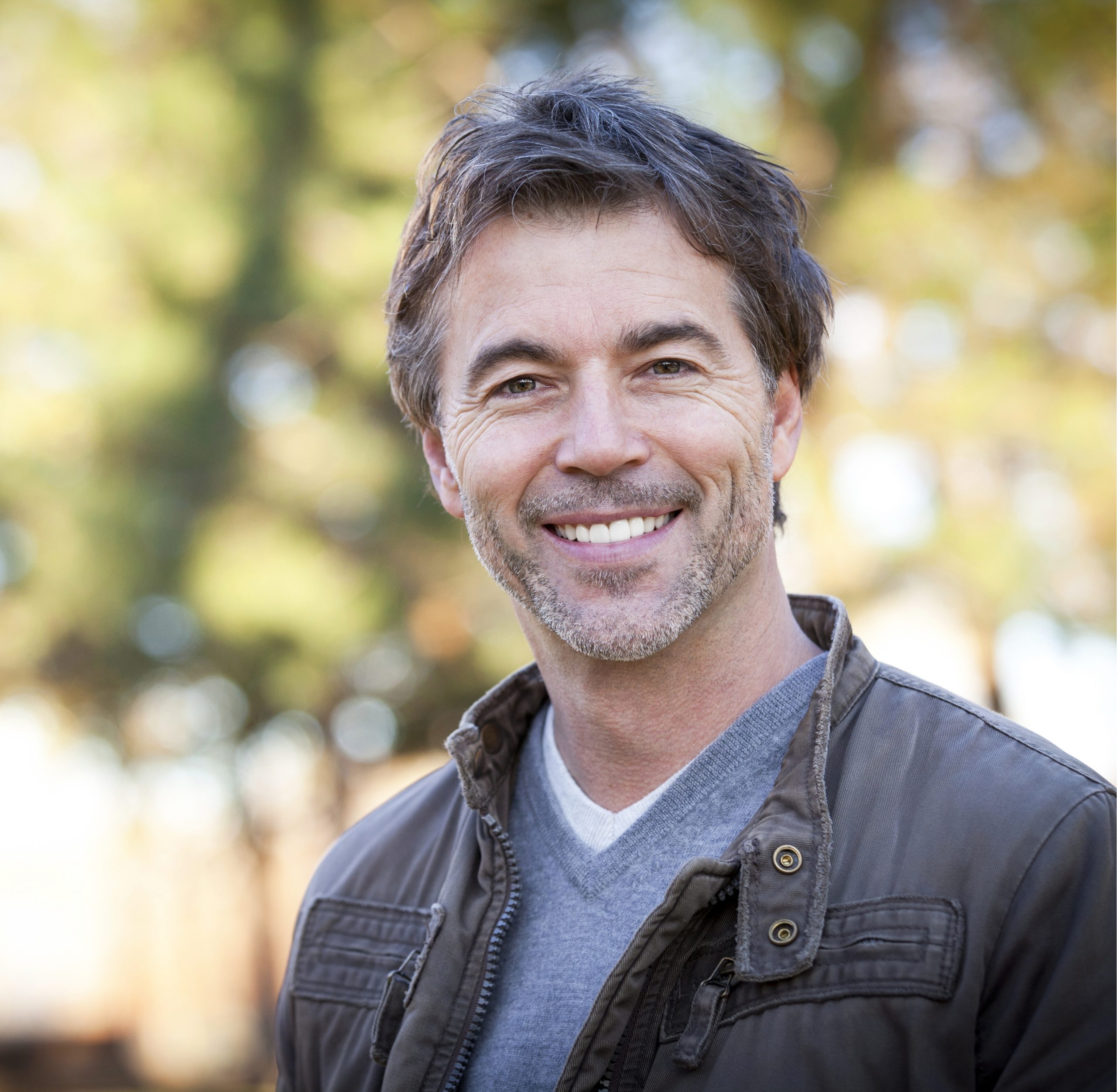 older man with a wide smile who has dental implants he got in Cache Valley